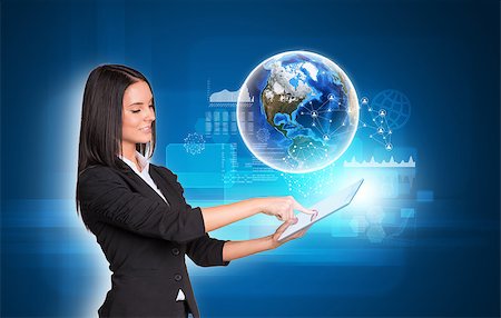 simsearch:400-07821752,k - Beautiful businesswomen in suit using digital tablet. Earth with transparent rectangles, graphs and network. Element of this image furnished by NASA Foto de stock - Royalty-Free Super Valor e Assinatura, Número: 400-07821798