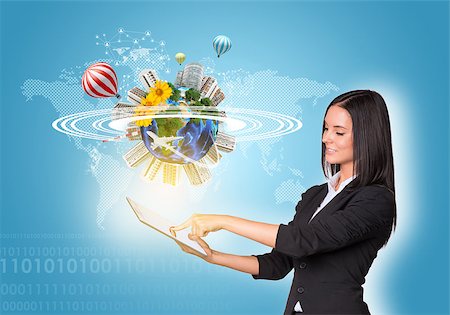 Beautiful businesswomen in suit using digital tablet. Earth with buildings, air balloons, flowers and airplane. Element of this image furnished by NASA Stock Photo - Budget Royalty-Free & Subscription, Code: 400-07821809