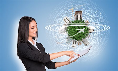 Beautiful businesswomen in suit using digital tablet. Green Earth with buildings, construction site and airplanes Stock Photo - Budget Royalty-Free & Subscription, Code: 400-07821825