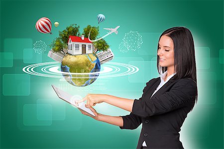 Beautiful businesswomen in suit using digital tablet. Earth with house, buildings, air balloons, trees and airplane. Element of this image furnished by NASA Stock Photo - Budget Royalty-Free & Subscription, Code: 400-07821858