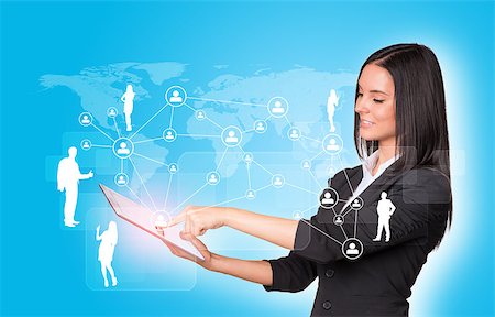 simsearch:400-07821752,k - Beautiful businesswomen in suit using digital tablet. Silhouettes of business people and network Foto de stock - Royalty-Free Super Valor e Assinatura, Número: 400-07821867