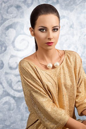 sexy woman with brown smooth hair wearing elegant golden dress and cute necklace. Stylish make-up, looking in camera Stock Photo - Budget Royalty-Free & Subscription, Code: 400-07822215