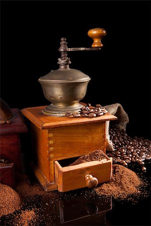 Coffee still life. Coffee grinder, ground coffee and coffee beans isolated on black background. Luxurious vintage coffee background. Photographie de stock - Aubaine LD & Abonnement, Code: 400-07822644