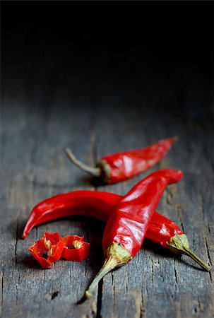 simsearch:400-07211737,k - Red hot chili peppers over wooden background Photographie de stock - Aubaine LD & Abonnement, Code: 400-07823131
