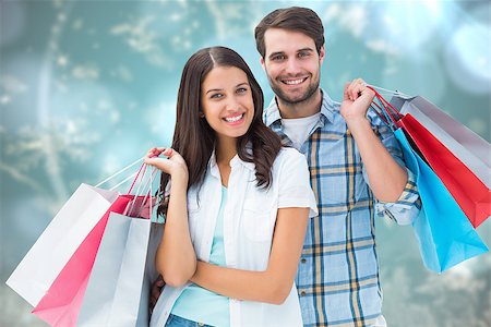 Happy couple with shopping bags against blurred christmas background Stock Photo - Budget Royalty-Free & Subscription, Code: 400-07834018