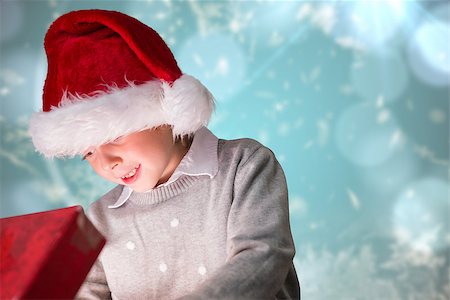simsearch:400-07753751,k - Festive boy opening gift against blurred christmas background Stock Photo - Budget Royalty-Free & Subscription, Code: 400-07834022