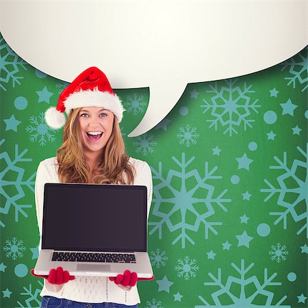 delicate electronics - Festive blonde showing a laptop against green vignette Stock Photo - Budget Royalty-Free & Subscription, Code: 400-07834324