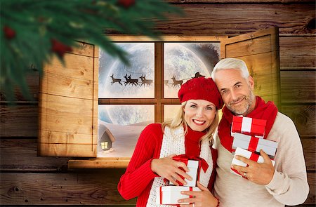 Happy festive couple with gifts against santa delivery presents to village Stock Photo - Budget Royalty-Free & Subscription, Code: 400-07834386
