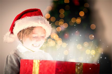 simsearch:400-07753751,k - Child opening his christmas present against snow Stock Photo - Budget Royalty-Free & Subscription, Code: 400-07834483