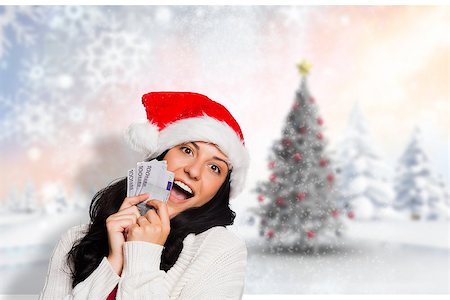 Woman holding money towards herself against blurry christmas scene Stock Photo - Budget Royalty-Free & Subscription, Code: 400-07834492