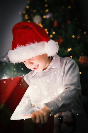 simsearch:400-07753751,k - Composite image of Child opening his christmas present against snow Stock Photo - Budget Royalty-Free & Subscription, Code: 400-07834579