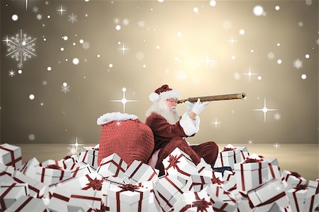 Santa looking through a telescope against grey room Stock Photo - Budget Royalty-Free & Subscription, Code: 400-07834611