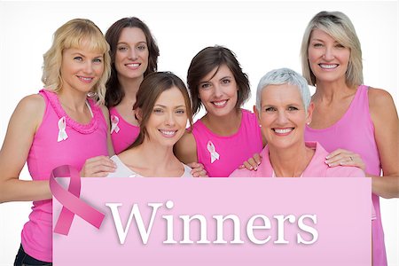 simsearch:400-06932887,k - Smiling women posing and wearing pink for breast cancer against pink card Fotografie stock - Microstock e Abbonamento, Codice: 400-07834837