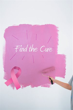 simsearch:400-07834992,k - Woman painting her wall pink against pink breast cancer awareness ribbon Fotografie stock - Microstock e Abbonamento, Codice: 400-07834989