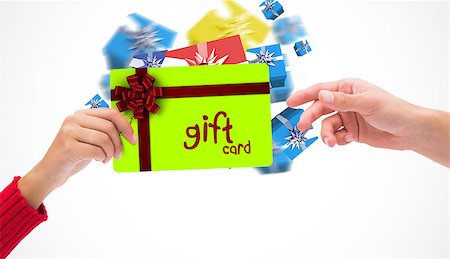 simsearch:400-07834588,k - Hands holding card against gift card with festive bow Fotografie stock - Microstock e Abbonamento, Codice: 400-07835023