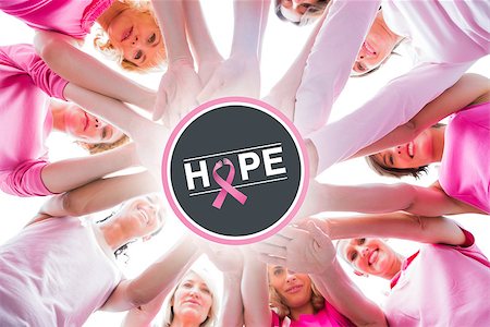 simsearch:400-06932887,k - Diverse women smiling in circle wearing pink for breast cancer against breast cancer awareness message on poster Fotografie stock - Microstock e Abbonamento, Codice: 400-07835042