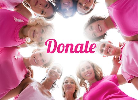 simsearch:400-06932887,k - Cheerful women smiling in circle wearing pink for breast cancer on white background Fotografie stock - Microstock e Abbonamento, Codice: 400-07835097