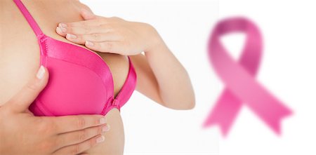 simsearch:400-06870717,k - Closeup of woman performing self breast examination against breast cancer awareness ribbon Stock Photo - Budget Royalty-Free & Subscription, Code: 400-07835106