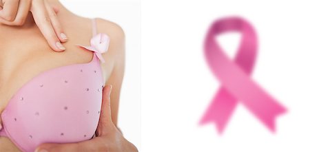 simsearch:400-06870717,k - Extreme closeup of woman performing self breast examination against breast cancer awareness ribbon Stock Photo - Budget Royalty-Free & Subscription, Code: 400-07835117