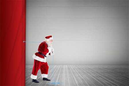 simsearch:6102-07844119,k - Santa claus pulling rope against grey room Stock Photo - Budget Royalty-Free & Subscription, Code: 400-07835317