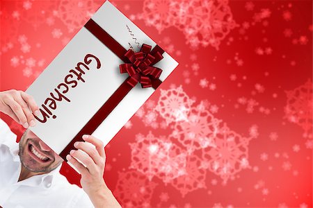 simsearch:400-07834588,k - Festive man holding christmas gift against digitally generated delicate snowflake design Fotografie stock - Microstock e Abbonamento, Codice: 400-07835384