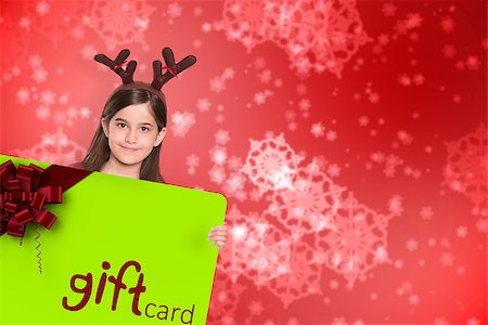 simsearch:400-07834588,k - Festive little girl showing card against digitally generated delicate snowflake design Fotografie stock - Microstock e Abbonamento, Codice: 400-07835385