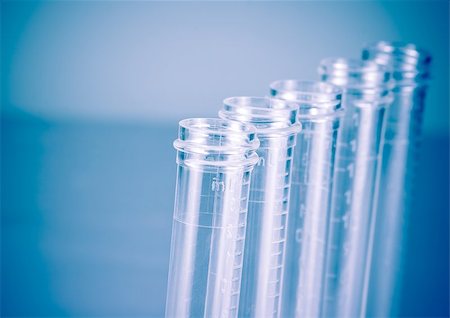 detail of the test tubes in laboratory on blue light tint background with space for text Foto de stock - Super Valor sin royalties y Suscripción, Código: 400-07836407