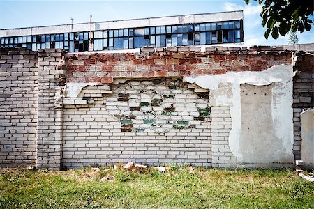 simsearch:400-07574451,k - Abandoned factory behind old brick fence on a sunny day Photographie de stock - Aubaine LD & Abonnement, Code: 400-07837430