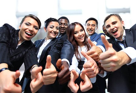 Successful business people with thumbs up and smiling Stock Photo - Budget Royalty-Free & Subscription, Code: 400-07838637
