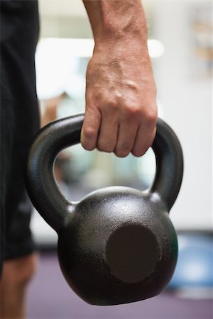 Close up of a cropped man holding kettle bell in the gym Stock Photo - Budget Royalty-Free & Subscription, Code: 400-07839165