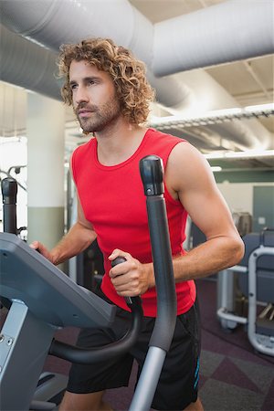 simsearch:400-07925663,k - Determined young man working out on x-trainer in the gym Stockbilder - Microstock & Abonnement, Bildnummer: 400-07839203