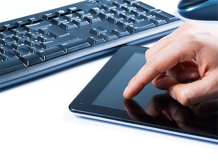 hand touching tablet near keyboard on white table, concept of new technology Stock Photo - Budget Royalty-Free & Subscription, Code: 400-07839813