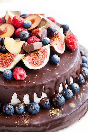 Homemade chocolate frosted cake decorated with fresh fruit Stock Photo - Budget Royalty-Free & Subscription, Code: 400-07830245
