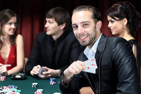 Poker players sitting around a table at a casino Stock Photo - Budget Royalty-Free & Subscription, Code: 400-07831338