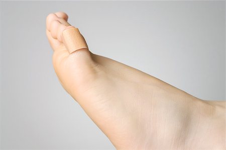 Injured female toe with adhesive bandage Stock Photo - Budget Royalty-Free & Subscription, Code: 400-07831485