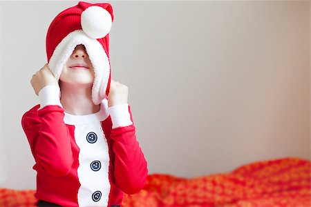 silly winter boy - little boy in elf costume pulling hat down and being silly at christmas time at home Stock Photo - Budget Royalty-Free & Subscription, Code: 400-07831507