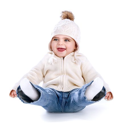 Little baby having fun in the studio isolated on white background, sitting on the floor with legs up, wearing warm stylish hat, winter activity concept Stock Photo - Budget Royalty-Free & Subscription, Code: 400-07831651