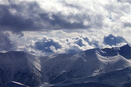 simsearch:400-05157183,k - Evening sunlight mountain and silhouette of parachutist. Caucasus Mountains. Georgia, ski resort Gudauri. Photographie de stock - Aubaine LD & Abonnement, Code: 400-07831799