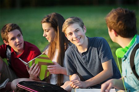Smiling confident male teenager with friends outdoors Stock Photo - Budget Royalty-Free & Subscription, Code: 400-07831965