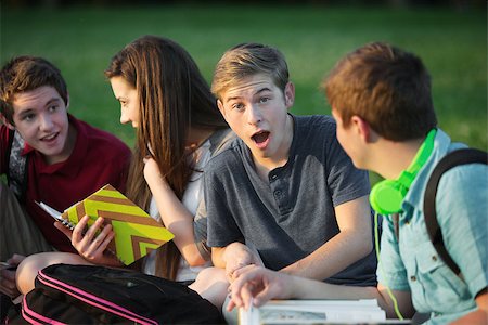 Surprised young student with group of friends outdoors Stock Photo - Budget Royalty-Free & Subscription, Code: 400-07831966