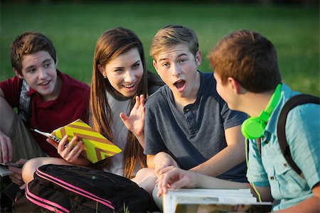 Surprised male student gossiping with friends outdoors Stock Photo - Budget Royalty-Free & Subscription, Code: 400-07831967