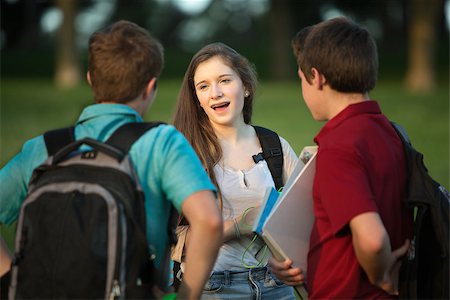 Three friends, girl and boys talking about homework outside Stock Photo - Budget Royalty-Free & Subscription, Code: 400-07831968