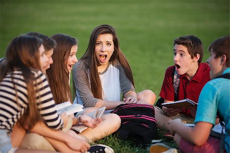 Shocked female teenage student sitting with friends Stock Photo - Budget Royalty-Free & Subscription, Code: 400-07831962