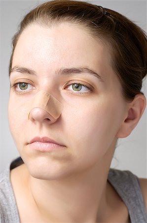 simsearch:400-07824013,k - Young woman with adhesive bandage on her nose Foto de stock - Royalty-Free Super Valor e Assinatura, Número: 400-07832546