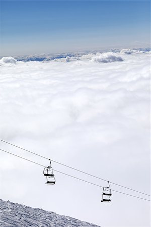 Ski slope, chair-lift and mountains under clouds. Caucasus Mountains, Georgia. Ski resort  Gudauri. Photographie de stock - Aubaine LD & Abonnement, Code: 400-07833346