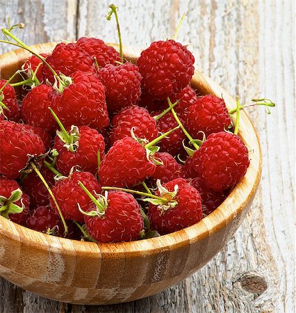 simsearch:400-08020671,k - Perfect Ripe Raspberries with Stems in Wooden Bowl Cross Section on Rustic Wooden background Stock Photo - Budget Royalty-Free & Subscription, Code: 400-07894158