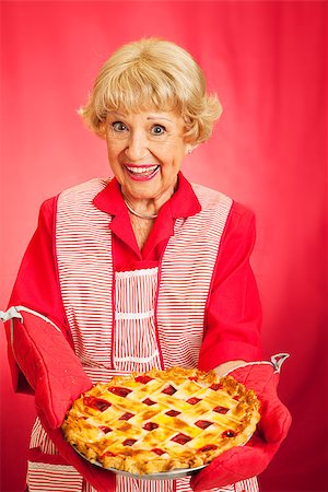 Sweet retro grandmother holding a beautiful homemade cherry pie. Stock Photo - Budget Royalty-Free & Subscription, Code: 400-07894524