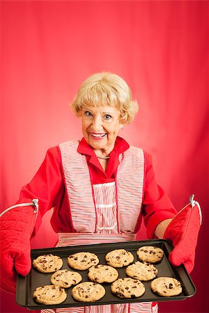 Sweet old fashioned grandma holding a tray of her homemade cookies.  Room for text. Stock Photo - Budget Royalty-Free & Subscription, Code: 400-07894521
