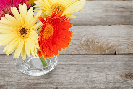 Colorful gerbera flowers on wooden table with copy space Stock Photo - Budget Royalty-Free & Subscription, Code: 400-07894853