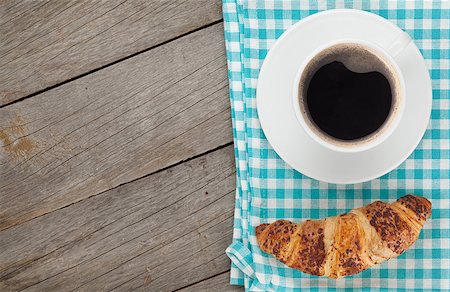 simsearch:400-06142439,k - Cup of coffee and fresh croissant on wooden table with copy space Stock Photo - Budget Royalty-Free & Subscription, Code: 400-07894886